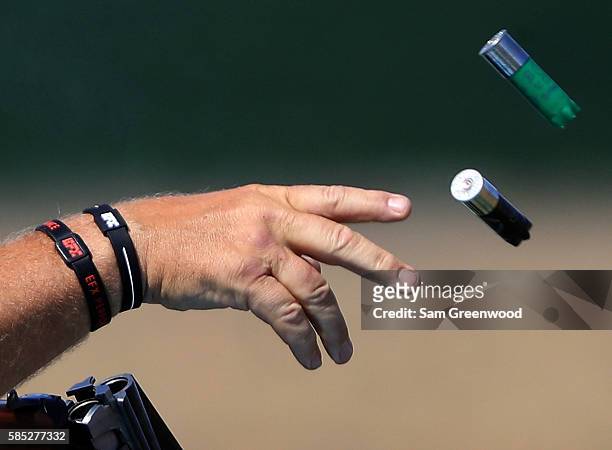 Hakan Dahlby of Sweden tosses empty shotgun hulls during a practice session at the Olympic Shooting center on August 2, 2016 in Rio de Janeiro,...