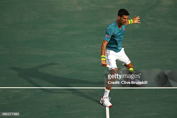 Novak Djokovic of Serbia plays a backhand during a practice session ahead of the Rio 2016 Olympic Games at the Olympic Tennis Centre on August 2,...