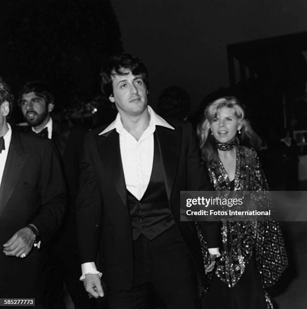 Actor Sylvester Stallone holding hands with his wife Sasha Czack at the 49th Academy Awards, Los Angeles, March 28th 1977.