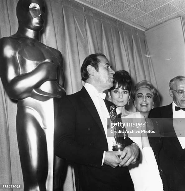 Actors Rex Harrison , Audrey Hepburn, Joan Crawford and George Cukor, all associated with the film 'My Fair Lady', at the 37th Academy Awards, Los...