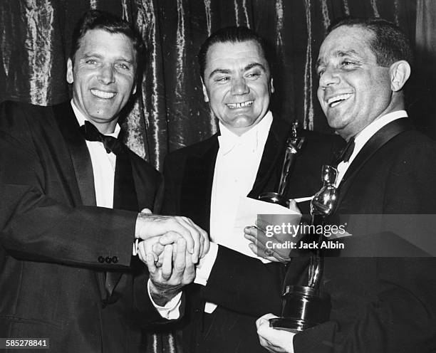 Actor Ernest Borgnine and director Harold Hecht holding their Oscars for the film 'Marty', being congratulated by actor Burt Lancaster , at the 28th...
