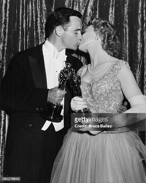 Actors Jack Lemmon and Jo Van Fleet holding their Oscars and kissing at the 28th Academy Awards, Los Angeles, March 21st 1956.