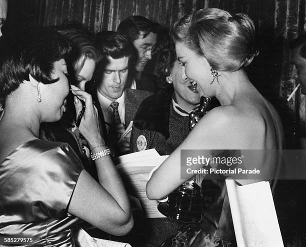 Actress Joanna Woodward talking to reporters after winning the Best Actress Oscar for the film 'Three Faces of Eve', at the 29th Academy Awards,...