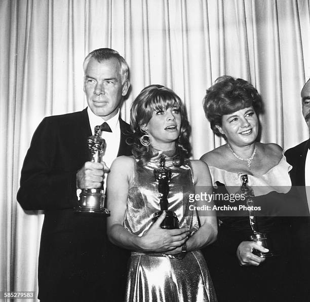 Actors Lee Marvin, Julie Christie and Shelley Winter holding their acting Oscars at the 38th Academy Awards, Los Angeles, April 18th 1966.