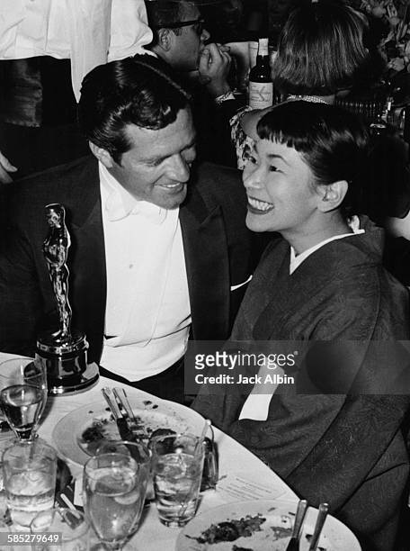 Actress Miyoshi Umeki with her Best Supporting Actress Oscar for the film 'Sayonara', sitting with Hugh O'Brien, at the 30th Academy Awards, Los...