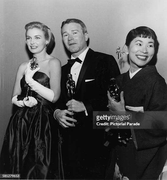 Actors Joanne Woodward, Red Buttons and Miyoshi Umeki holding their Oscars, at the 30th Academy Awards, Los Angeles, March 26th 1958.