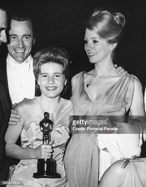 Actress Patty Duke holding her Best Supporting Actress Oscar for the film 'The Miracle Worker', with Robert Vaughn and Inger Stevens, at the 35th...