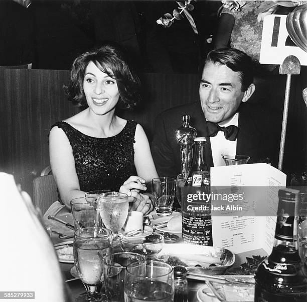 Actor Gregory Peck sitting with his wife and his Oscar, for his role in the film 'To Kill a Mockingbird', at the 35th Academy Awards, Los Angeles,...