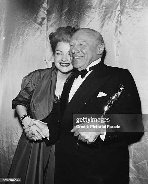 Actor Edmund Gwenn holding his Oscar for the film 'Miracle on 34th Street', with presenter Anne Baxter, at the 20th Academy Awards, Los Angeles,...