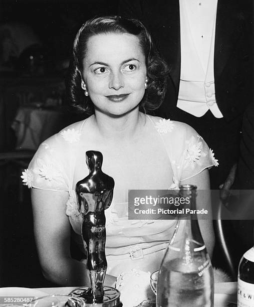 Actress Olivia de Havilland sitting with her Best Actress Oscar at her table, for the film 'The Heiress', at the 22nd Academy Awards, Los Angeles,...