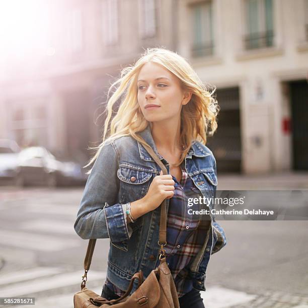 a 18 years old young woman walking in the street - hair flying stock-fotos und bilder