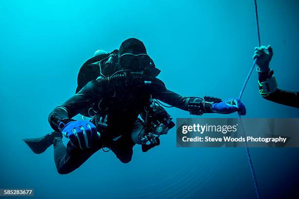 underwater view of technical diver using a rebreather device to locate shipwreck, lombok, indonesia - decompression sickness stock pictures, royalty-free photos & images