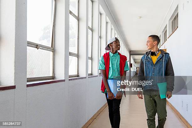 students walking down hallway, chatting - walking boy school stock pictures, royalty-free photos & images