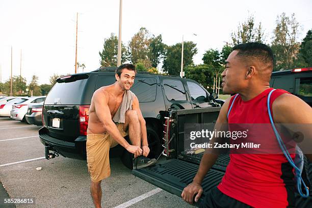two male friends getting ready for workout - riverside stock-fotos und bilder