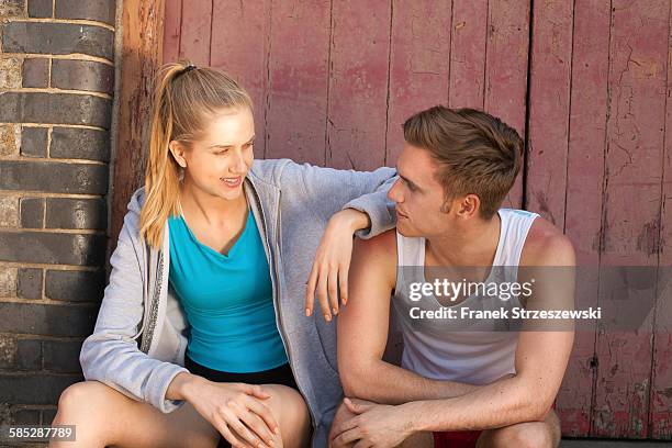 runners resting in front of building door - coupeville stock pictures, royalty-free photos & images