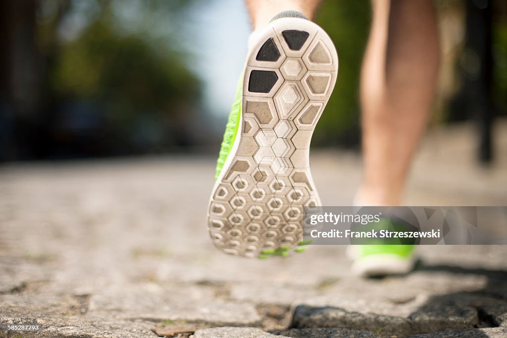 Runner jogging on cobbled street