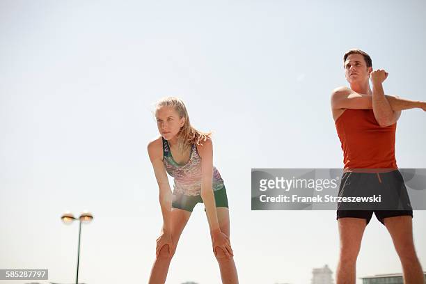 runners stretching during exercise - coupeville stock pictures, royalty-free photos & images