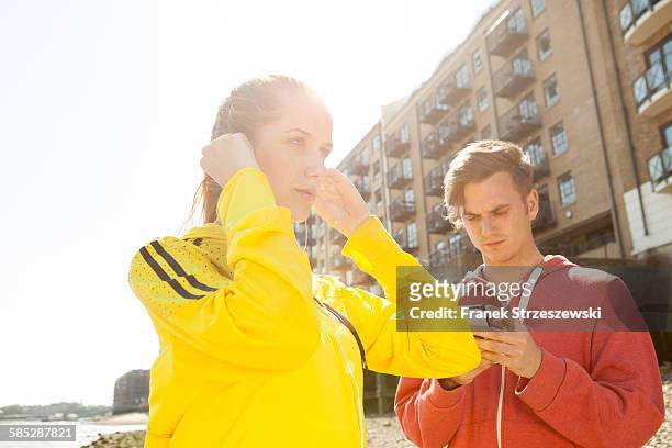 runners standing by building block, wapping, london - coupeville stock pictures, royalty-free photos & images