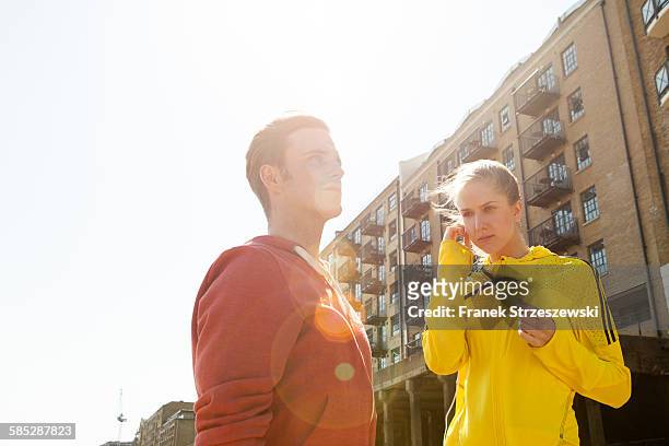 runners standing by building block, wapping, london - coupeville stock pictures, royalty-free photos & images