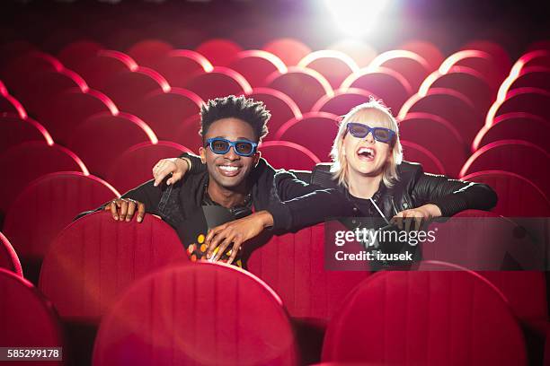 multi ethnic young couple in the 3d cinema - loving 2016 film stock pictures, royalty-free photos & images