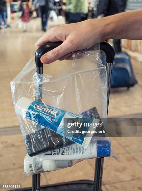 liquid items in transparent bag for security at airport - transparent bag stock pictures, royalty-free photos & images
