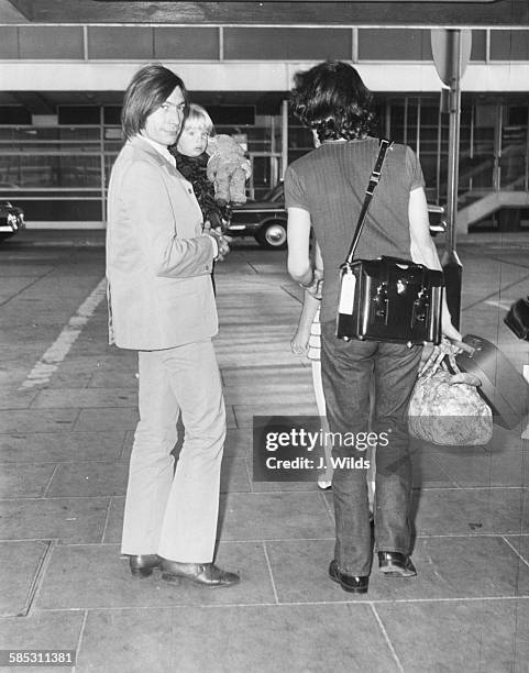 'The Rolling Stones' drummer Charlie Watts holding his young daughter Seraphina as they arrive at London Airport, October 17th 1969.