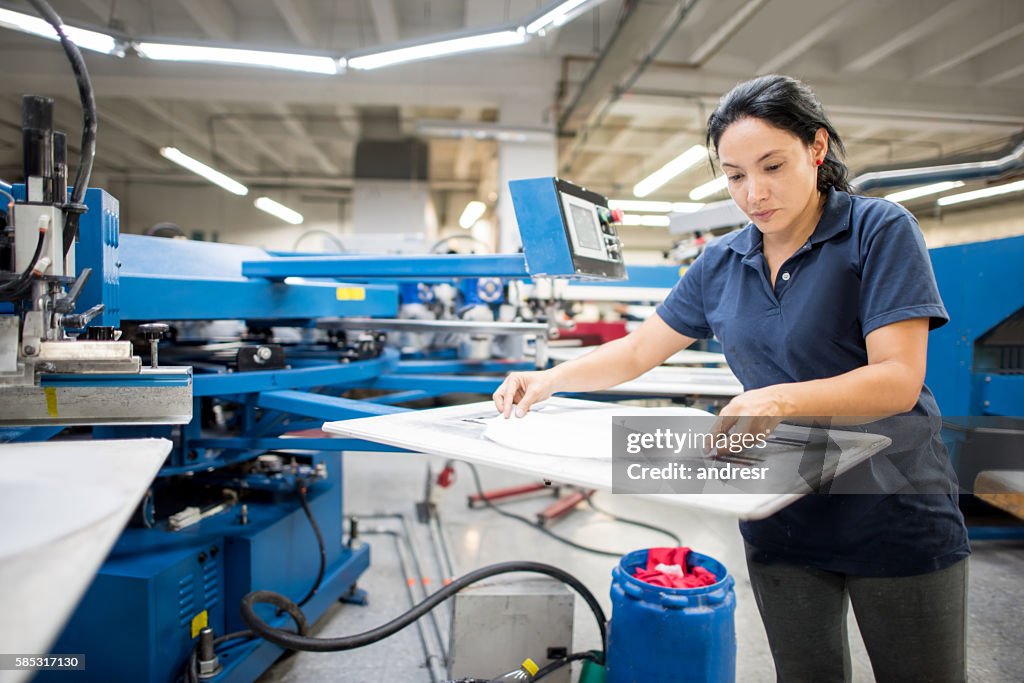 Worker ironing at a clothing factory