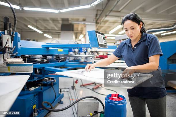 worker ironing at a clothing factory - appliance manufacturing stock pictures, royalty-free photos & images