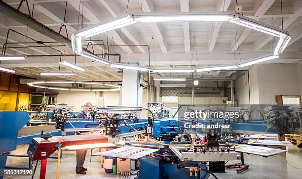 man textile printing at a factory - textile printing stock pictures, royalty-free photos & images