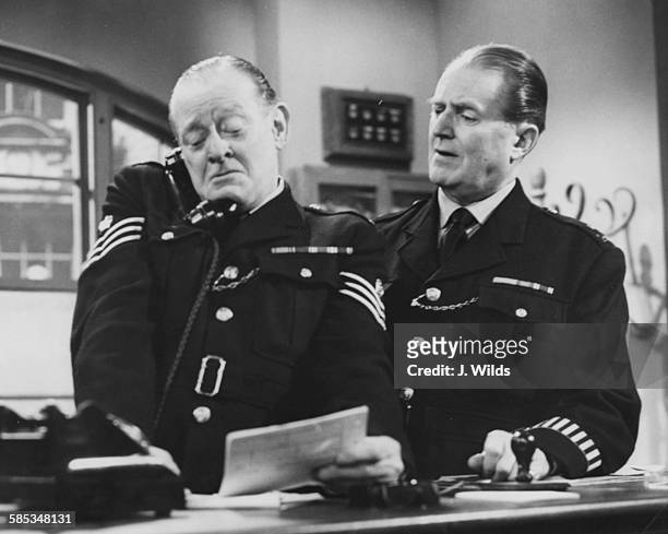 Actors Arthur Rigby and Jack Warner in police uniform during rehearsals for the BBC television show 'Dixon of Dock Green', London, August 25th 1963.