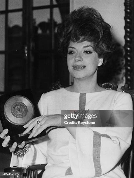 Italian actress and singer Katyna Ranieri holding her 'golden record' award in Rome, January 29th 1962.