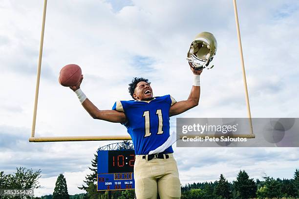 teenage american football player celebrating on soccer pitch - american football player celebrating stock pictures, royalty-free photos & images