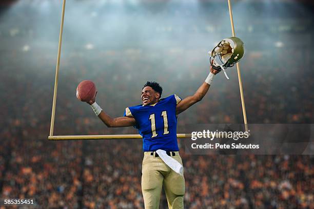 teenage american football player celebrating victory in soccer stadium - american culture stockfoto's en -beelden