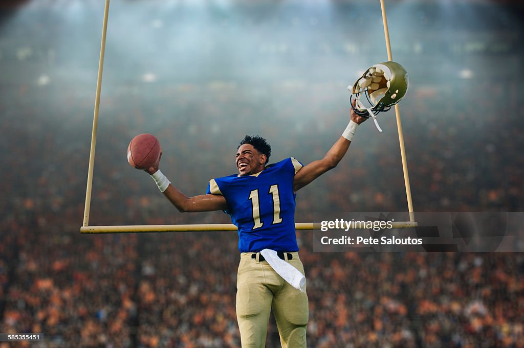 Teenage American football player celebrating victory in soccer stadium