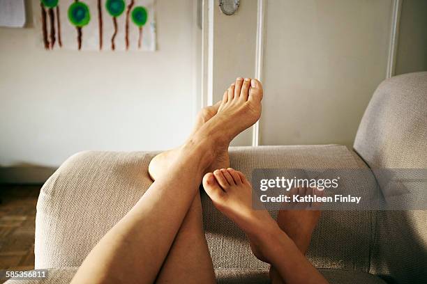 mother and son relaxing on sofa, feet up, focus on feet - kids feet in home stock pictures, royalty-free photos & images