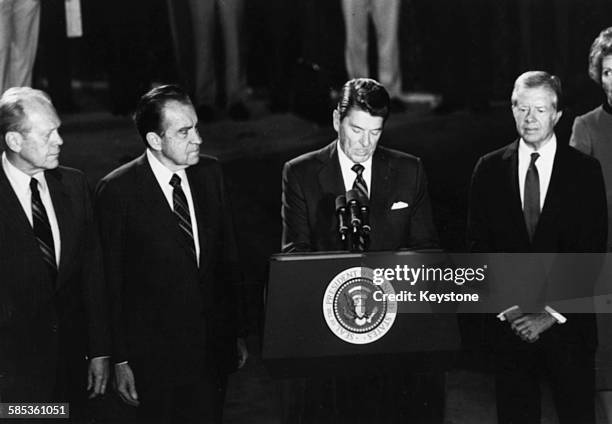 President Ronald Reagan speaking with three former US Presidents Gerald Ford, Richard Nixon, Reagan and Jimmy Carter, as they eulogize Egyptian...