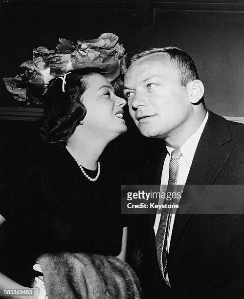 Actress Jeff Donnell leaning in to kiss her husband Aldo Ray on the cheek, at an event in Hollywood, CA, circa 1955.