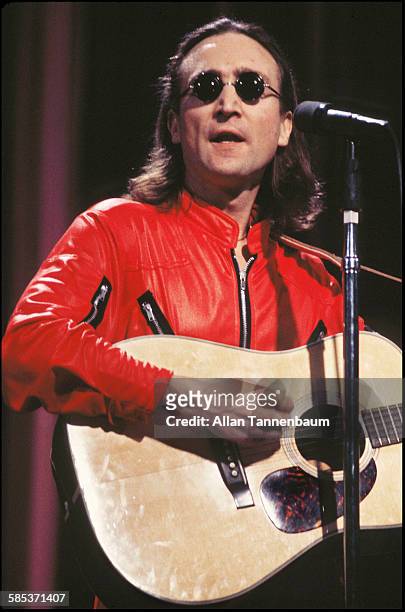 Close-up of British musician John Lennon as he plays guitar onstage at the Hilton Hotel's Grand Ballroom, New York, New York, April 18, 1975. The...