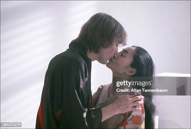 Portrait of married musicians John Lennon and Yoko Ono, both dressed in kimonos, as they kiss in a SoHo gallery, New York, New York, November 26,...