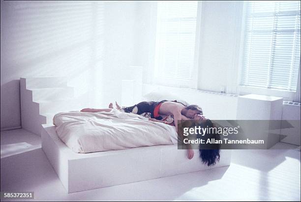 Portrait of married musicians John Lennon and Yoko Ono, as they lie together on a bed in a SoHo gallery, New York, New York, November 26, 1980. The...