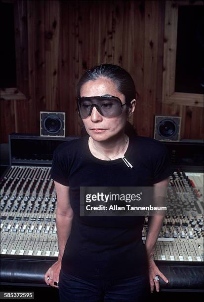 Portrait of Japanese-born artist and musician Yoko Ono as she leans on her Studio One mixing board, New York, New York, June 5, 1981.