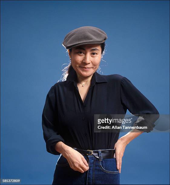 Portrait of Japanese-born artist and musician Yoko Ono as she poses against a blue background, New York, New York, November 20, 1980. The photo was...