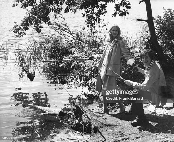 Actors Alan Price and Jill Townsend fishing on the lake during a break in filming 'Alfie Darling' at Black Park, near Pinewood Studios, England,...
