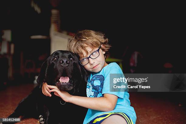 Boy Cuddling with Dog