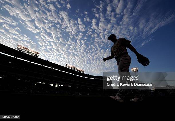 Ryon Healy of the Oakland Athletics walks back to the dugout after warming up prior to the start of the baseball game against the Los Angeles Angels...