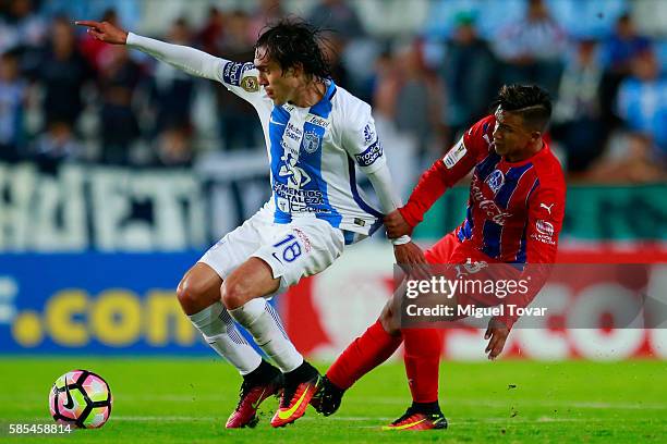 Joaquin Martinez of Pachuca fights for the ball with Michael Chirinos of Olimpia during a match between Pachuca and Olimpia as part of Liga de...