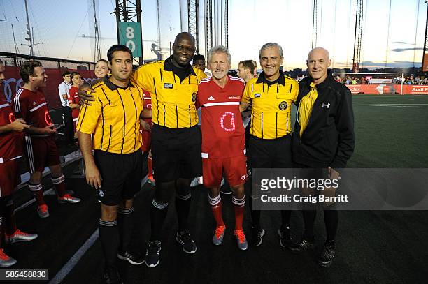 Former FC Bayern Munich footballer Paul Breitner poses with referees before the Audi Player Index Pick-Up Match at Chelsea Piers on August 2, 2016 in...