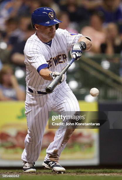 Jake Elmore of the Milwaukee Brewers lays down a sacrifice bunt during the seventh inning against the Pittsburgh Pirates at Miller Park on July 29,...