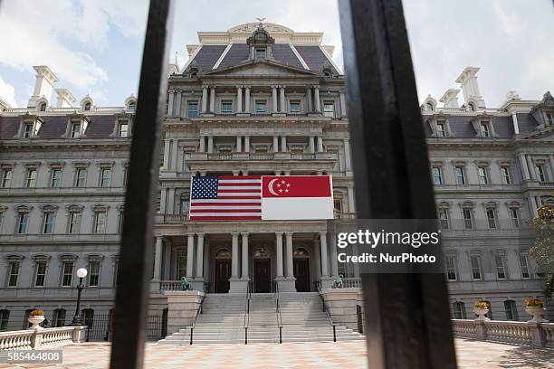 Washington, D.C. On Tuesday, August 2, United States and Singapore flags hang on the front of the Eisenhower Executive Office Building, in honor of a...