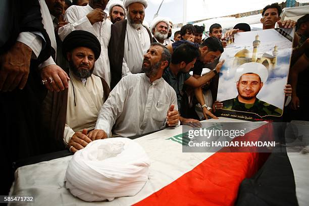 Iraqis mourn over the coffins of Shiite students who were killed in the Khalidiyah area of Iraq's Anbar province fighting alongside pro-government...